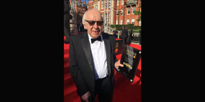 Image of Edwin Shaw on the Olivier Awards red carpet holding his Be Inspired plaque